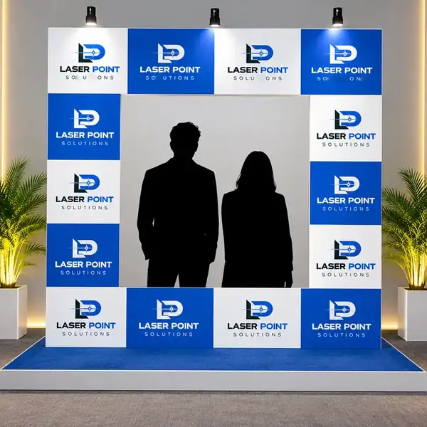 Laser Point Solutions branded photo booth backdrop with step and repeat wall at an outdoor event